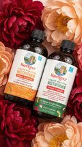 Two bottles of Mary Ruth's Liquid Morning Multivitamin surrounded by flowers
